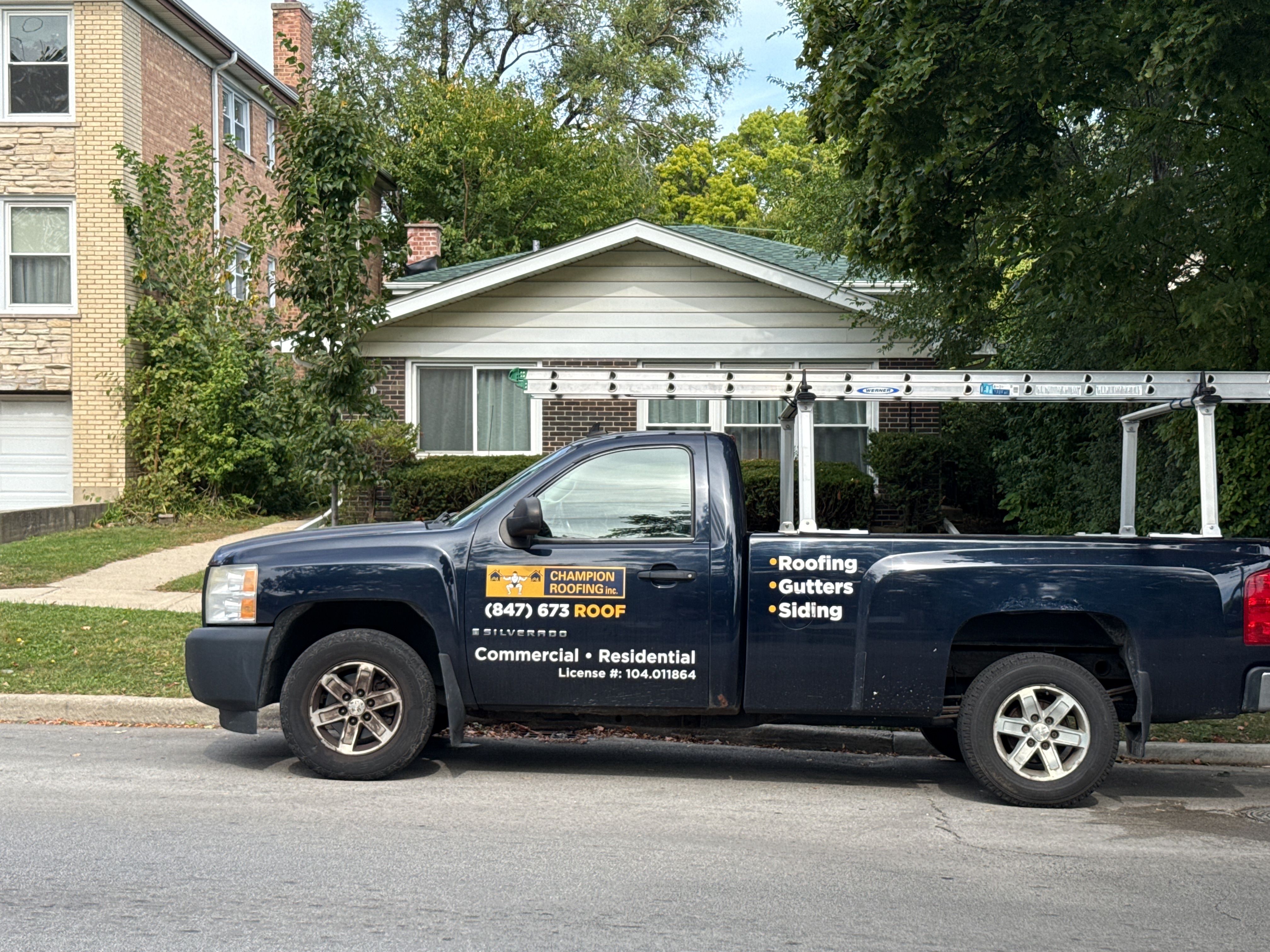 Champion Roofing work truck parked in front of residential home in Chicago.