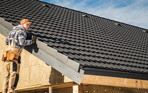 roofer working on ceramic roof tile